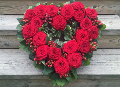 Krans i hjärtform med röda rosor för begravning i Uppsala